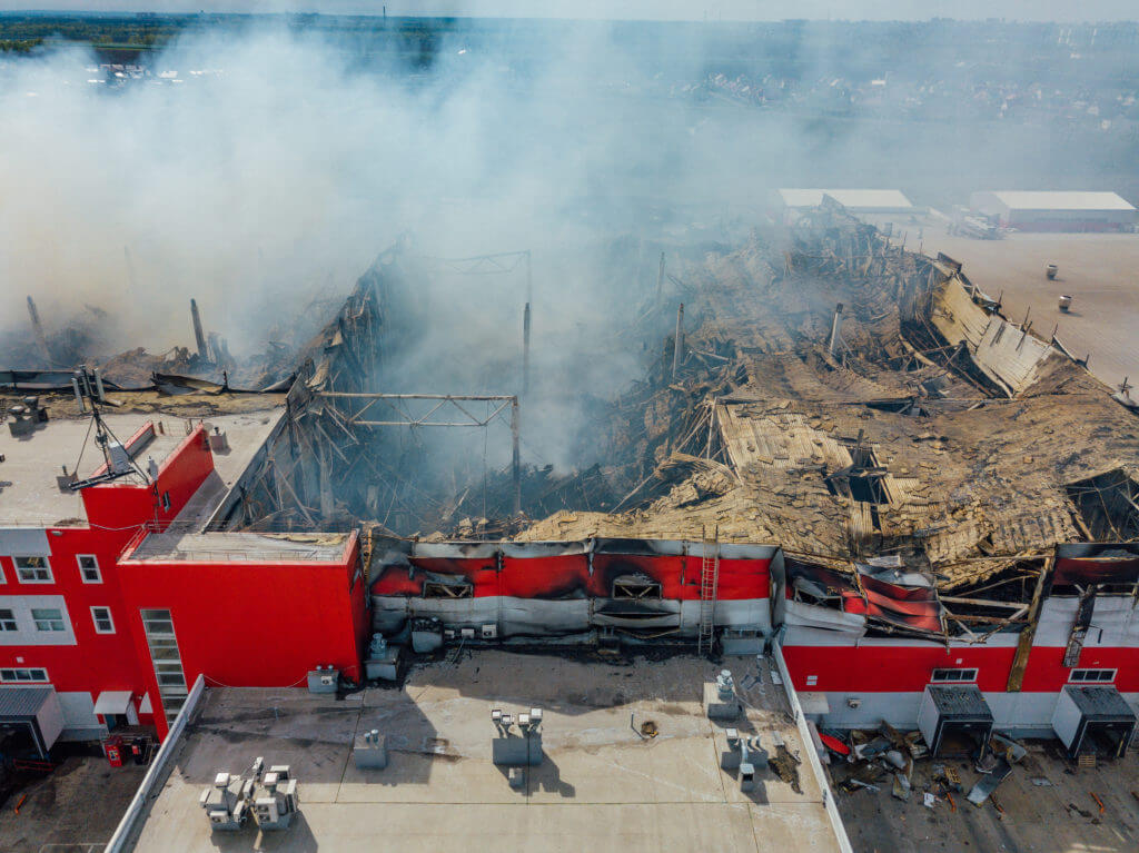 Aerial view of burning industrial distribution warehouse.